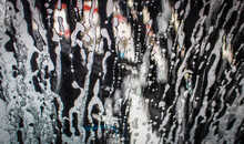 Background - Going Through An Automatic Car Wash - Soapy Water Blowing Up Window With Dark Blur Outside.j