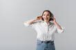 © LIGHTFIELD STUDIOS - excited plus size woman in wireless headphones listening music isolated on grey
