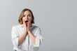 © LIGHTFIELD STUDIOS - surprised overweight woman in white shirt isolated on grey