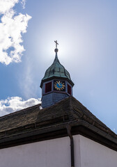 Wall Mural - Old church and striking clock in sunshine in Germany