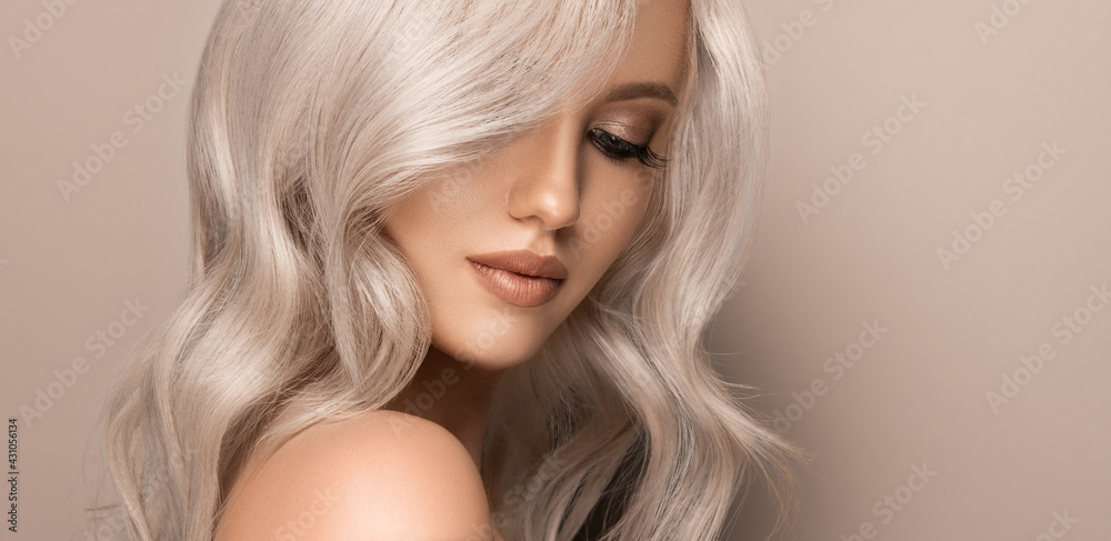 Beautiful girl with hair coloring in ultra blond. Stylish hairstyle curls done in a beauty salon. Fashion, cosmetics and makeup - obrazy, fototapety, plakaty 