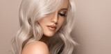 Fototapeta  - Beautiful girl with hair coloring in ultra blond. Stylish hairstyle curls done in a beauty salon. Fashion, cosmetics and makeup