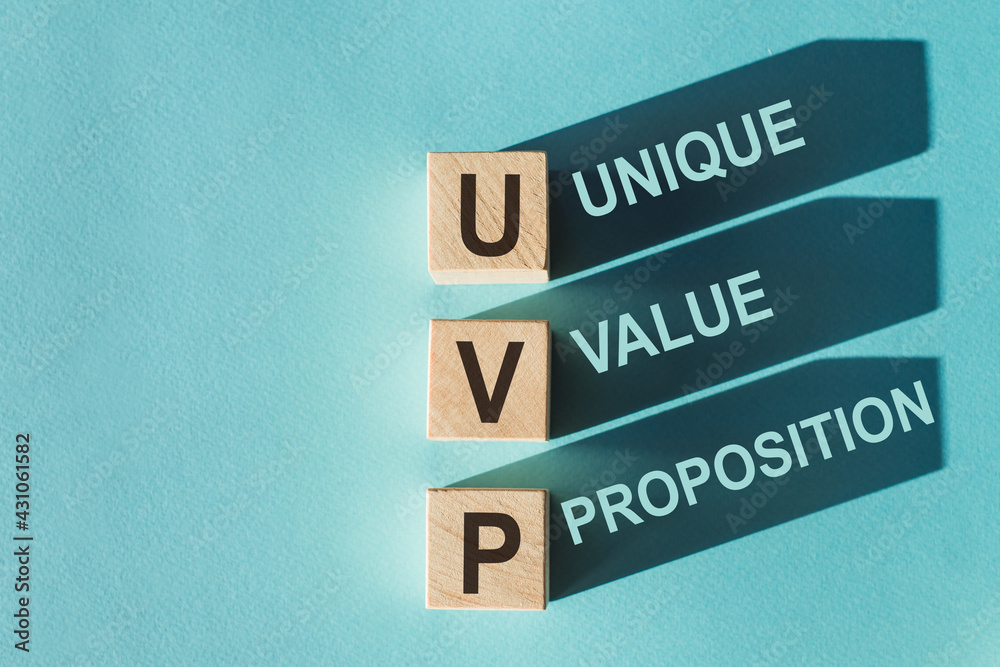 Uvp Table Example Wooden cubes building word UVP - (abbreviation Unique Value Proposition ...