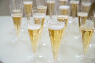 Delicious sparkling wine in plastic glasses on the buffet table. Copyspace