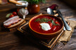 Traditional Ukrainian borscht . Bowl of red beet root soup borsch with white cream . Beet Root delicious soup . Traditional Ukraine food cuisine
