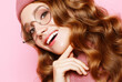 beautiful young female model with long wavy hair wearing pink beret , scarf and eyeglasses