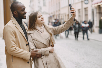 Mixed couple spenting time together in a spring city