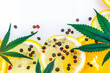 Cannabis Terpene concept with leafs lemons orange and peppercorns isolated on white