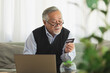 Asian Elderly man use cradit card shopping online