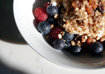 Sticker - Delicious bowl of muesli with blueberries and raspberries for breakfast