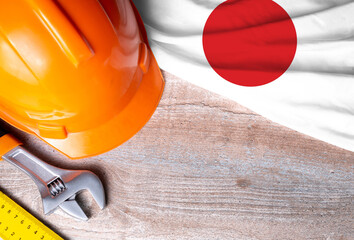 Japan flag with different construction tools on wood background, with copy space for text. Happy Labor day concept.