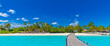 © icemanphotos - Maldives paradise scenery. Tropical aerial landscape, seascape with long jetty, water villas with amazing sea and lagoon beach, tropical nature. Exotic tourism destination banner, summer vacation