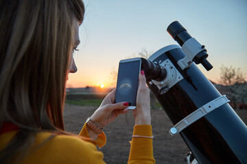 Wall Mural - woman looking at night sky with amateur astronomical telescope.