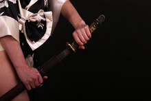 Female Hand On The Katana Sword On Black Background