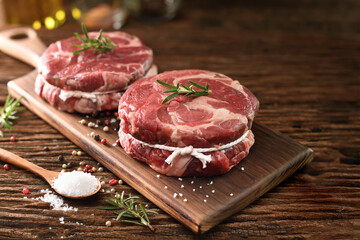 Canvas Print - Fresh raw pieces of beef meat on a cutting board