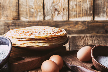 Wall Mural - Pancakes on rustic table, ingredients, making blini crepes