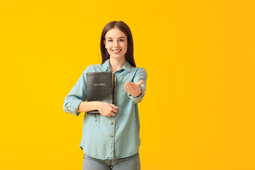 Sticker - Young woman with Bible on color background
