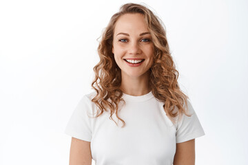 smiling blond woman with white perfect smile and natural face, looking happy and confident at camera