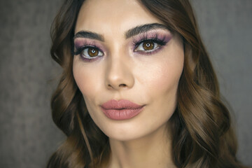 Closeup portrait of beautiful woman with bright make-up and pink lips. Attractive model with a pink lipstick.