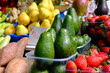 Fresh avocados and strawberries at a greengrocer market