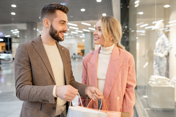 Poster - A man and a woman discussing what they bought in the mall