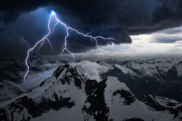 Wall Mural - Dark Dramatic Mountain Landscape with Stormy Cloud. Thunder and Lightning Sky Artistic Render. Aerial Landscape from British Columbia, Canada.