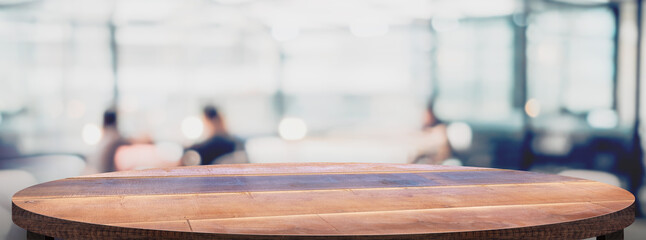 Fototapete - Empty round wood table with cafe restaurant blur background.copy space for display of product on online media advertise