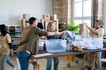 Sticker - Happy females choosing donation clothes from containers on table