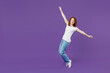 © ViDi Studio - Full length young happy fun cheerful redhead caucasian woman 20s wear white basic casual t-shirt jeans leaning back standing on toes dancing isolated on dark violet color background studio portrait