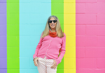 Wall Mural - Senior Woman Posing Against Bright Background