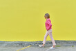 Senior Woman Walking Against Bright Background