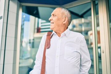 Wall Mural - senior businessman smiling happy walking at the city.
