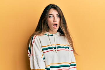 Canvas Print - Young caucasian woman wearing casual clothes afraid and shocked with surprise and amazed expression, fear and excited face.