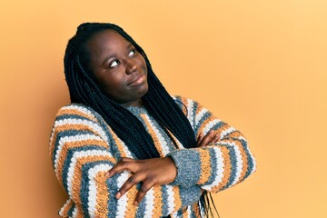 Sticker - Young black woman with braids wearing casual winter sweater looking to the side with arms crossed convinced and confident