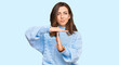 Young brunette woman wearing casual winter sweater doing time out gesture with hands, frustrated and serious face