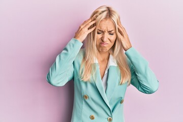 Canvas Print - Young blonde woman wearing business clothes suffering from headache desperate and stressed because pain and migraine. hands on head.