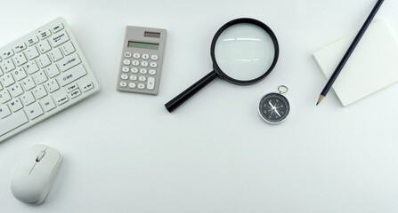 Wall Mural - Business objects of Pc,keyboard,mouse,pencil,compass and calculator,Magnifying glass on White table background