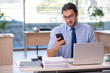 © Elnur - Young male accountant working in the office