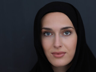 Portrait of modern young muslim woman in black abaya