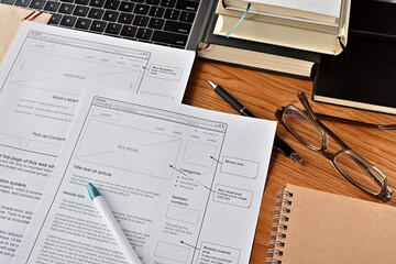 Poster - On the desk where I am doing web design. There is a wireframe printable and a pen.