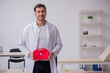 © Elnur - Young male doctor paramedic holding first aid bag
