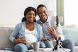 © Prostock-studio - Cheerful black bloggers broadcasting from home, pregnancy blog concept