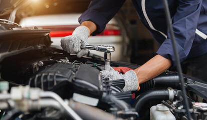 Automobile mechanic repairman hands repairing a car engine automotive workshop with a wrench, car service and maintenance,Repair service.