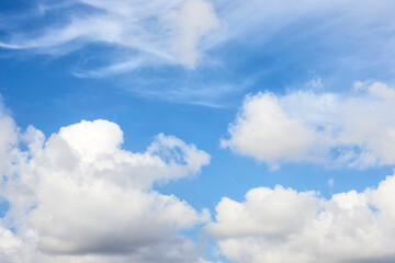 The blue sky with fluffy clouds