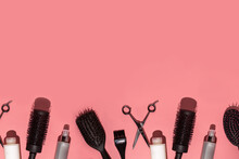 Hair Brushes, Scissors And Tools For Hair Dresser On Pink Background In Hard Light Arranged At The Bottom Creating A Frame, A Template