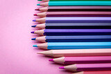 Fototapeta Tęcza - Colorful pencil set on pink background