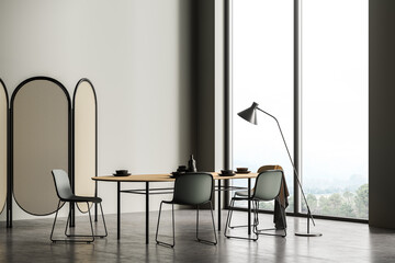 Modern eating room interior with dark green chairs and wooden table with dishes, concrete floor. Folding screen, panoramic window, 3D rendering