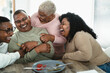© Alessandro Biascioli - Happy African family having fun after a lunch together at home - Food and parents unity concept