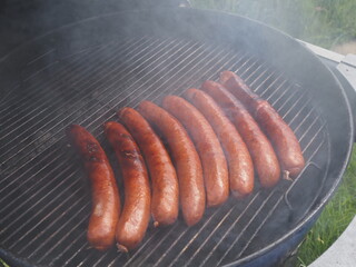 Farmer sausages smoked and grilled on the charcoal grill