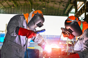 Industrial Worker at the factory welding closeup